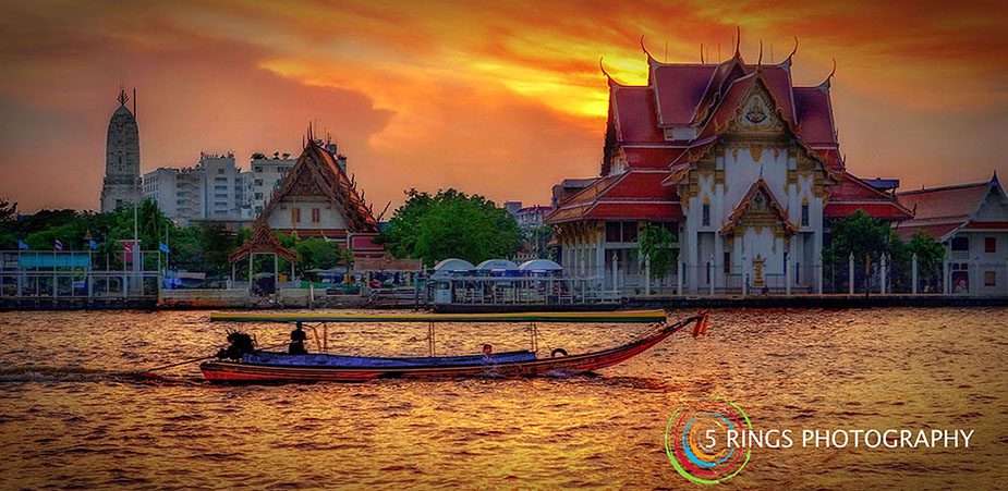 Photographer in Bangkok sunset on the river
